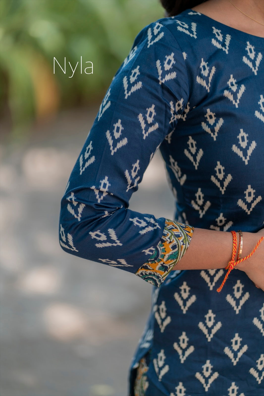 Elegant Silk cotton ikkat print kurti with potli button on yoke and kalamkari bottom and 3/4th sleeves